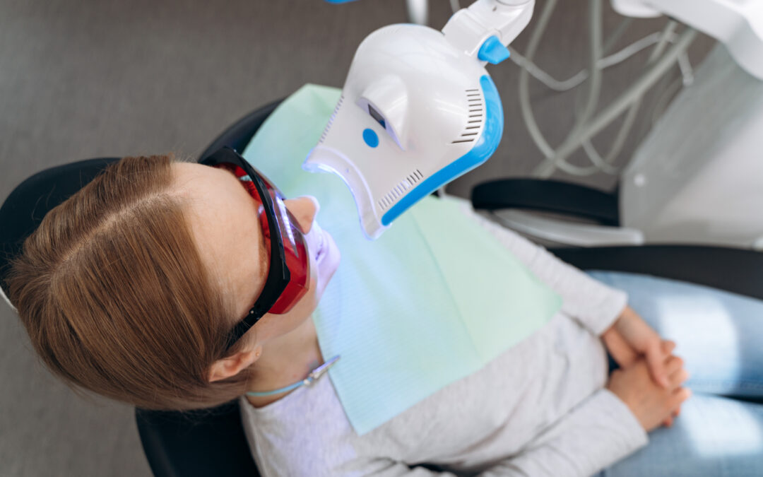 Young child receiving dental examination with intraoral camera in pediatric dental office setting.